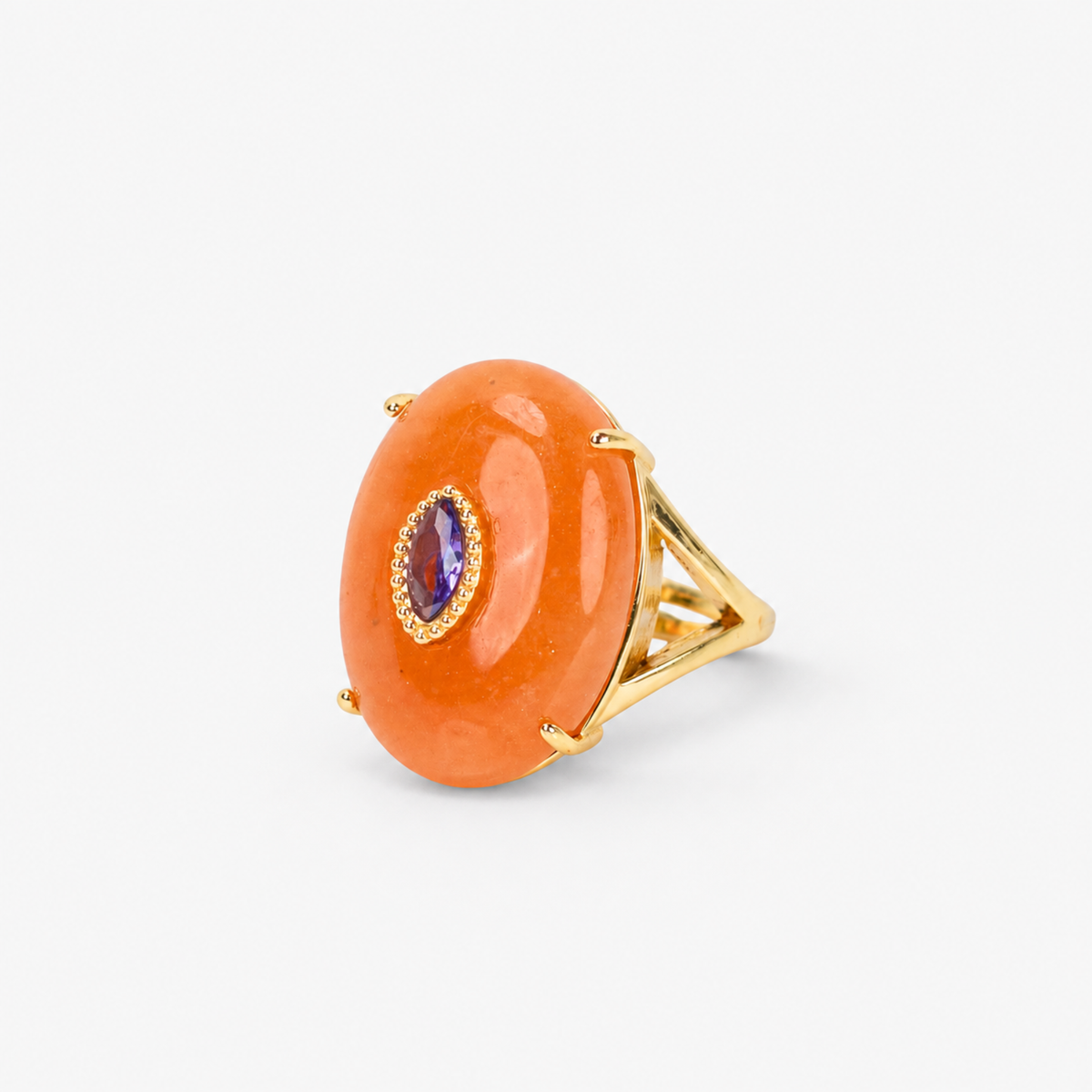 Orange statement ring featuring a polished stone, contrasting purple detail and Gold tone finish.