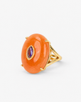 Orange statement ring featuring a polished stone, contrasting purple detail and Gold tone finish.