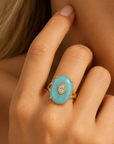 Sassy Jones Samira Teal ring featuring an oversized blue green stone in a sculptural gold setting.