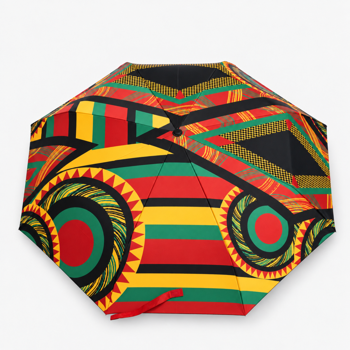 Sassy Jones patterned umbrella featuring a multicolor canopy with red, yellow, green and black detailing.