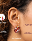 Red ladybug statement stud earrings decorated with small white pearls, clear crystals and glossy black accents.