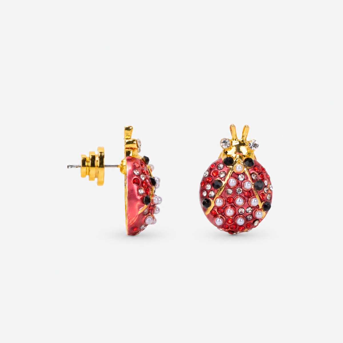 Scarlette 18k Dainty Pearl Studs - Ladybug,Earrings, Sassy Jones, Sassy Jones Scarlette Ladybug Earrings featuring dimensional red enamel bodies with pearl, crystal and gold details.
Dainty jeweled ladybug earrings featuring red, black and white detailing with pearls and sparkling crystal accents.