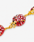 Sassy Jones Scarlette ladybug necklace featuring red, black and gold details with petite pearl-like embellishments.