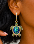 Sassy Jones Soleia statement earrings featuring jeweled sea turtle pendants suspended from crystal lined drops.