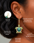 Colorful sea turtle dangle earrings featuring blue and green enamel detailing with a gleaming gold finish.