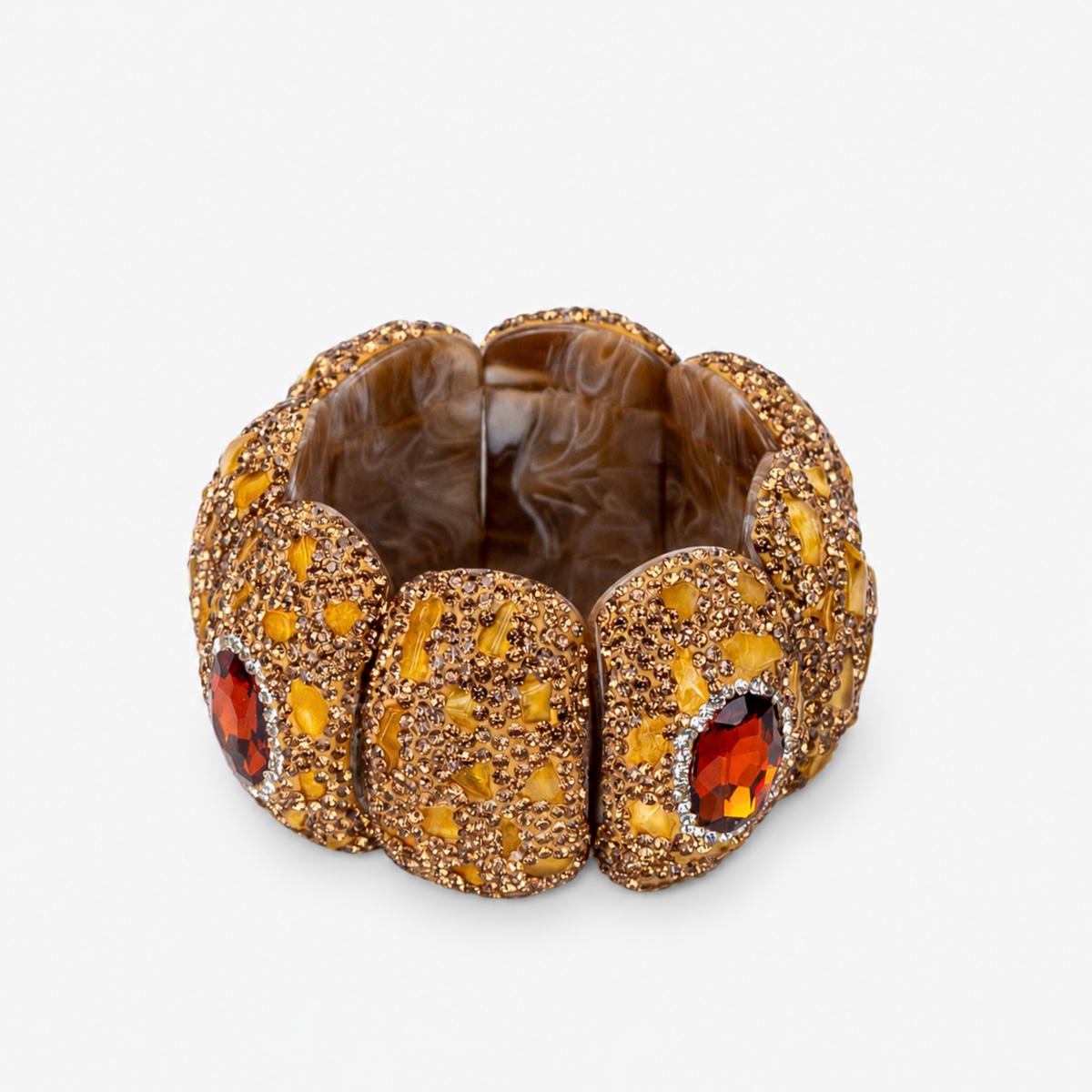 Amber statement bracelet featuring warm stone details, a faceted amber colored centerpiece and Gold tone finish.