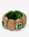 Emerald statement stretch bracelet featuring a large faceted green centerpiece and Gold tone finish detailing.
