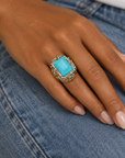 Sassy Jones Soraya Luxe Ring featuring an oversized teal stone framed by crystals and dimensional metallic accents.