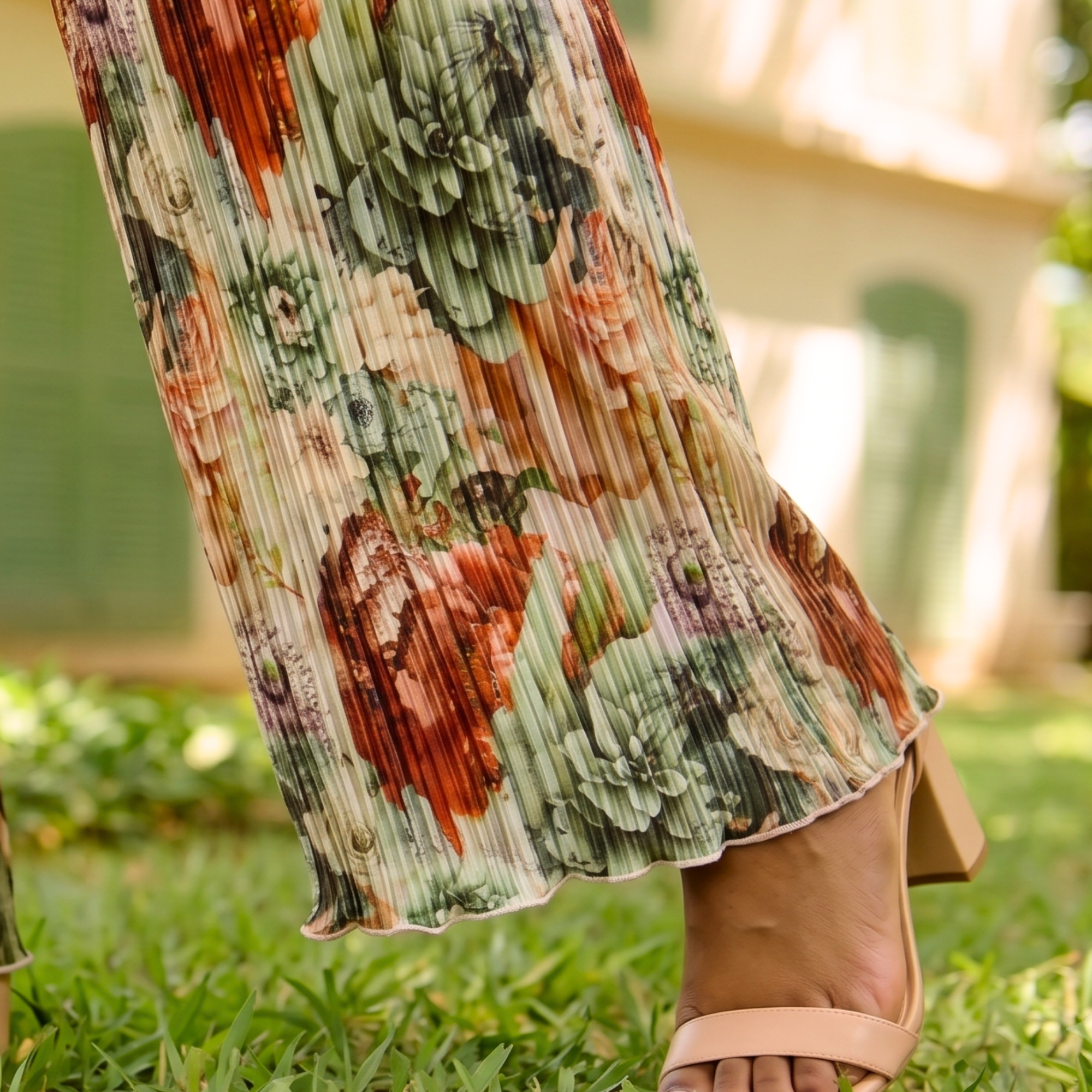 Women's silky pleated wide leg floral pants featuring a watercolor botanical print in sage, terracotta, blush, and cream with a comfortable pull on waistband.