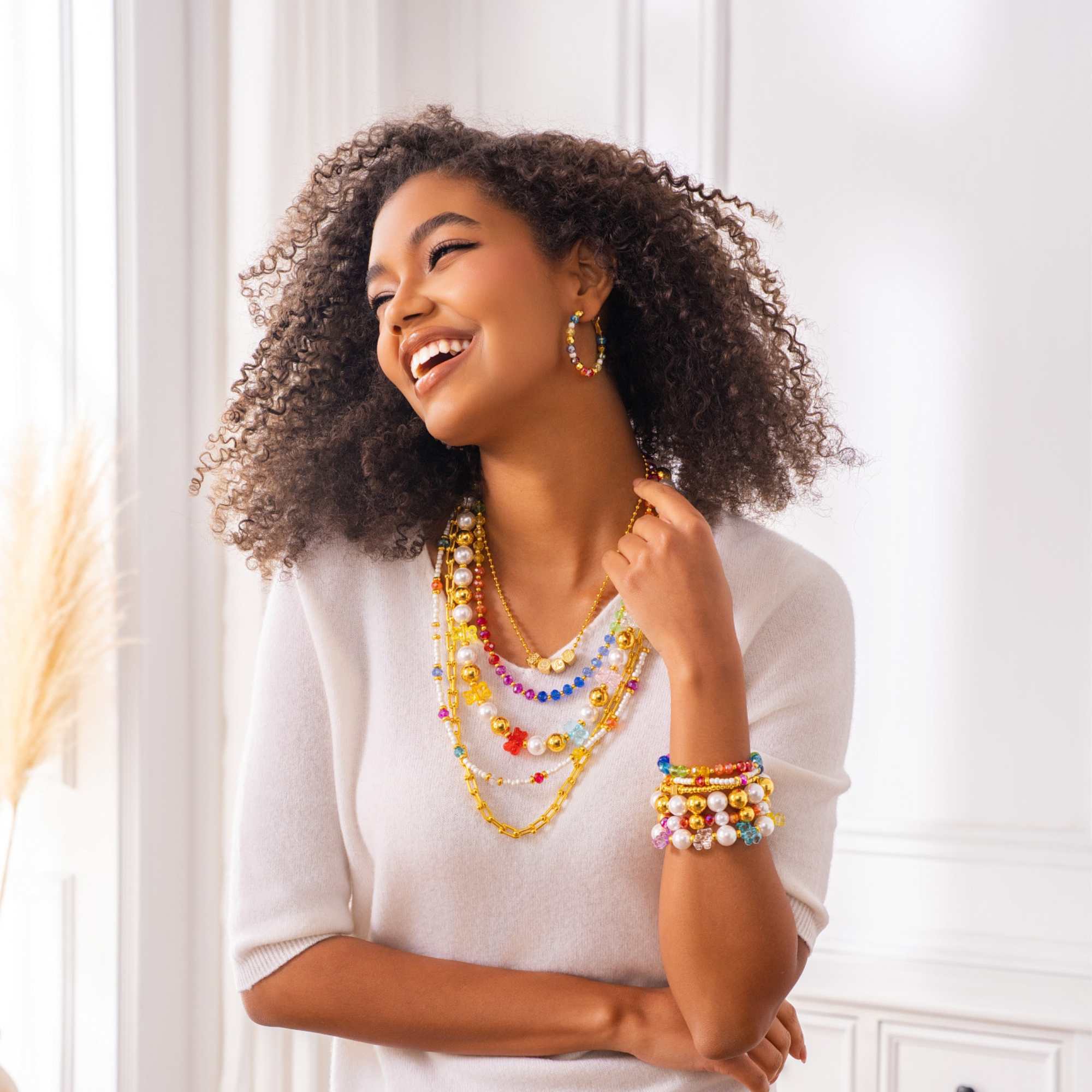 Colorful glass bead and pearl hoop earrings with gold accents designed for playful luxury styling