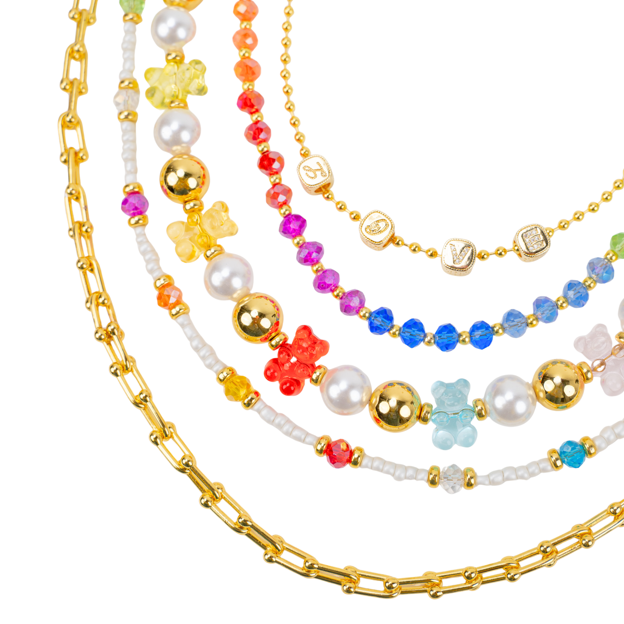 Layered 18k gold necklace with pearls, colorful beads, and playful teddy bear charms designed for fun luxury styling