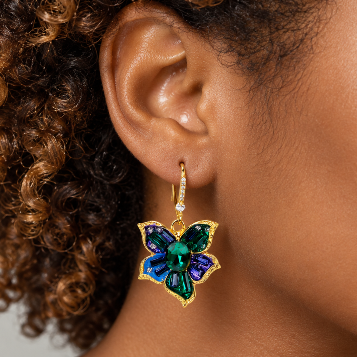 Sassy Jones Valerie floral dangle earrings featuring faceted green center stones and colorful crystal petals.