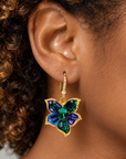 Sassy Jones Valerie floral dangle earrings featuring faceted green center stones and colorful crystal petals.
