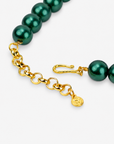 Vintage inspired necktie necklace featuring an olive green striped tie, emerald colored pearls and sparkling multicolor accents.