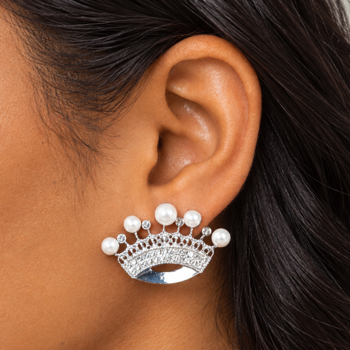 Silver colored crown earrings featuring graduated pearl accents and shimmering crystal embellishments.