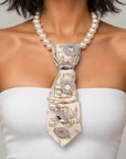 Vintage inspired statement necklace featuring luminous ivory pearl beads and an embellished cream necktie.