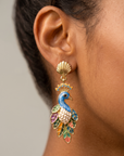 Close up of Victoriana Prissy Peacock Earring showing intricate enamel feathers, gold outlines and shell inspired stud.