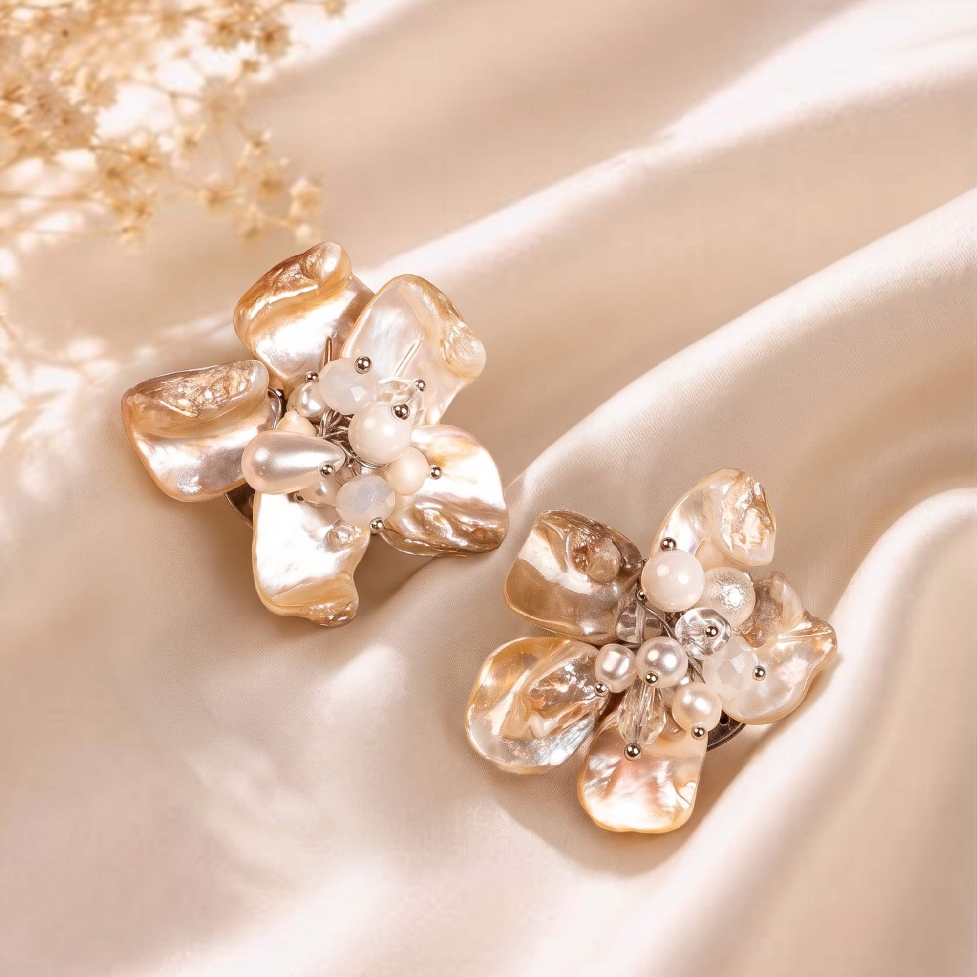 Statement floral earrings handcrafted from Mother of Pearl petals with freshwater pearl accents and sculptural botanical detailing.