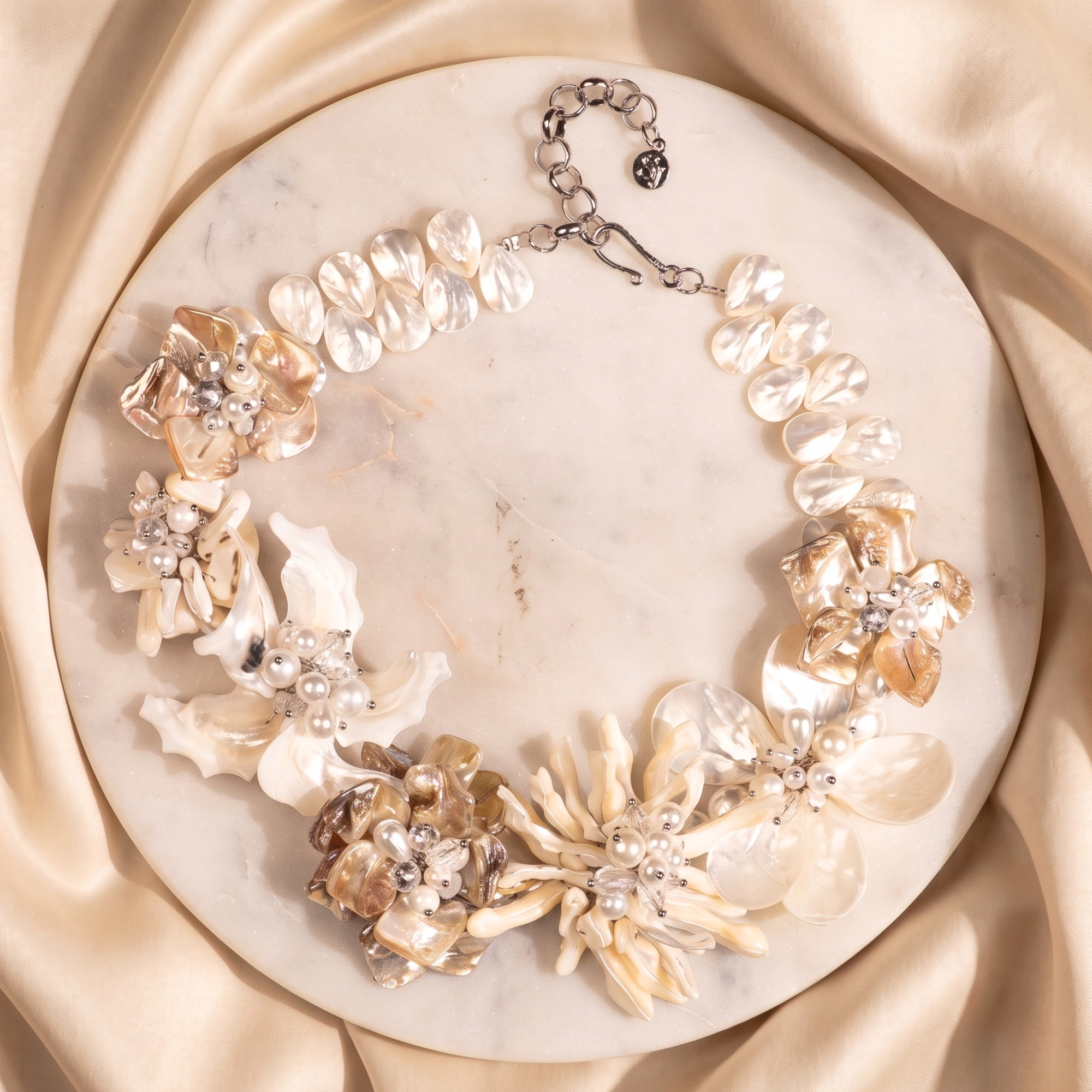 Statement necklace handcrafted from Mother of Pearl flowers, freshwater cultured pearls, Czech AB crystal accents, and sculptural floral detailing.