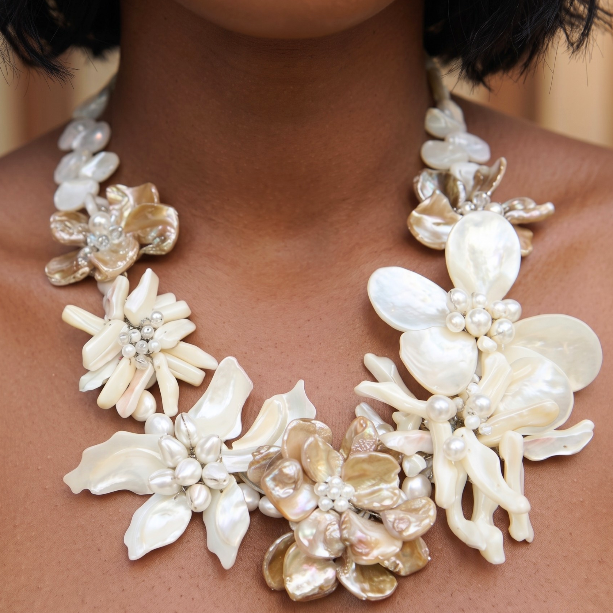 Statement necklace handcrafted from Mother of Pearl flowers, freshwater cultured pearls, Czech AB crystal accents, and sculptural floral detailing.