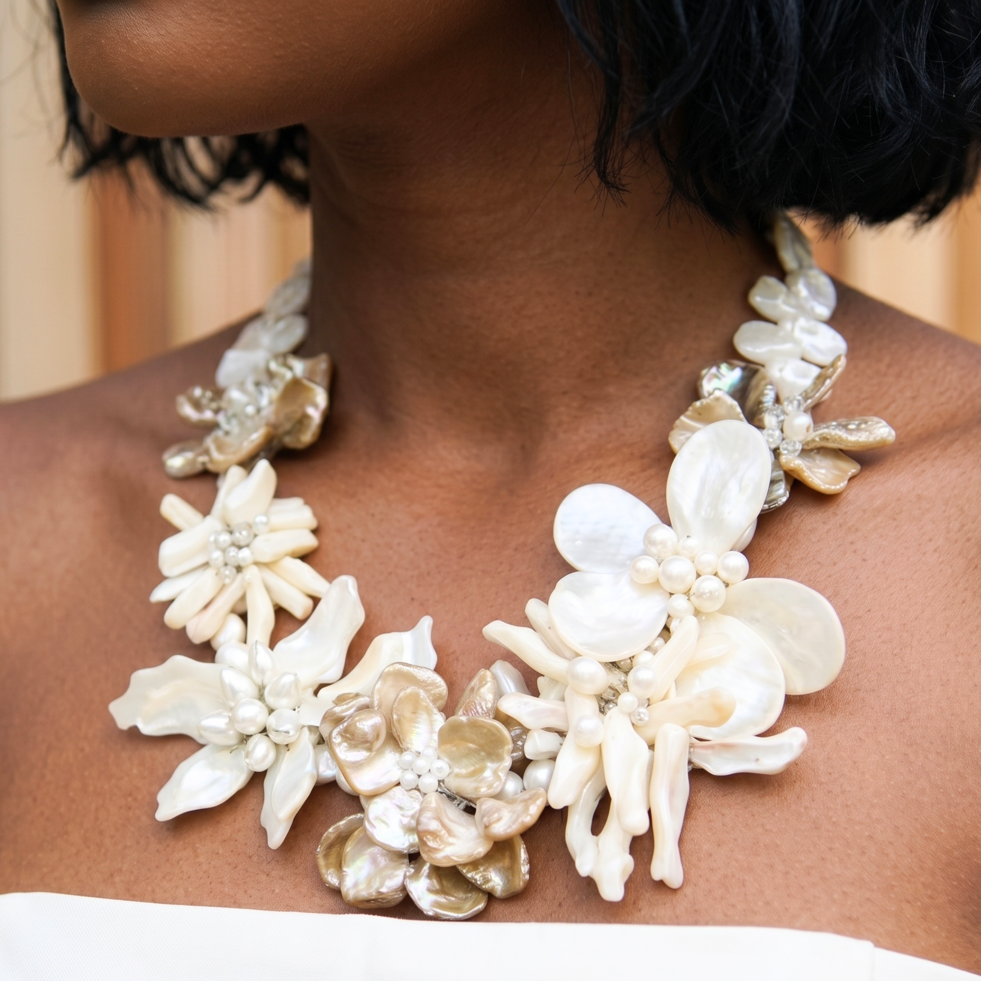 Statement necklace handcrafted from Mother of Pearl flowers, freshwater cultured pearls, Czech AB crystal accents, and sculptural floral detailing.