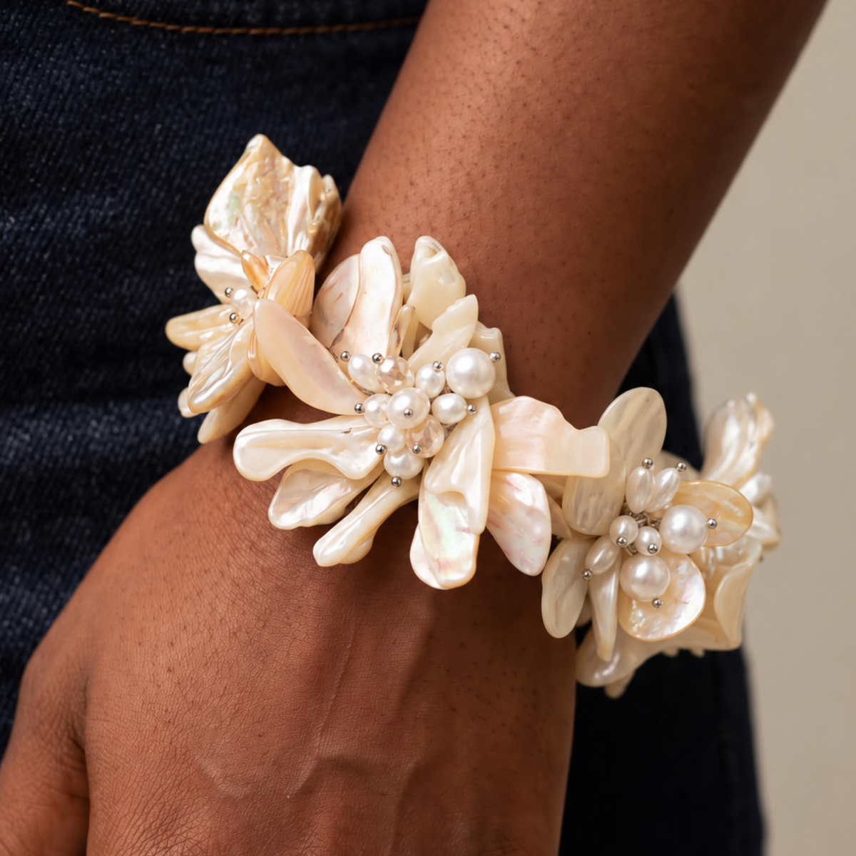 Wisteria Mother of Pearl statement bracelet featuring layered shell flowers in creamy ivory and champagne tones.