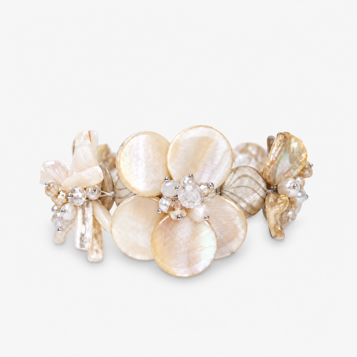 Mother of pearl floral statement bracelet with pearl cluster centers inspired by wisteria blossoms worn on a woman's wrist