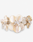  Mother of pearl floral statement bracelet with pearl cluster centers inspired by wisteria blossoms worn on a woman's wrist