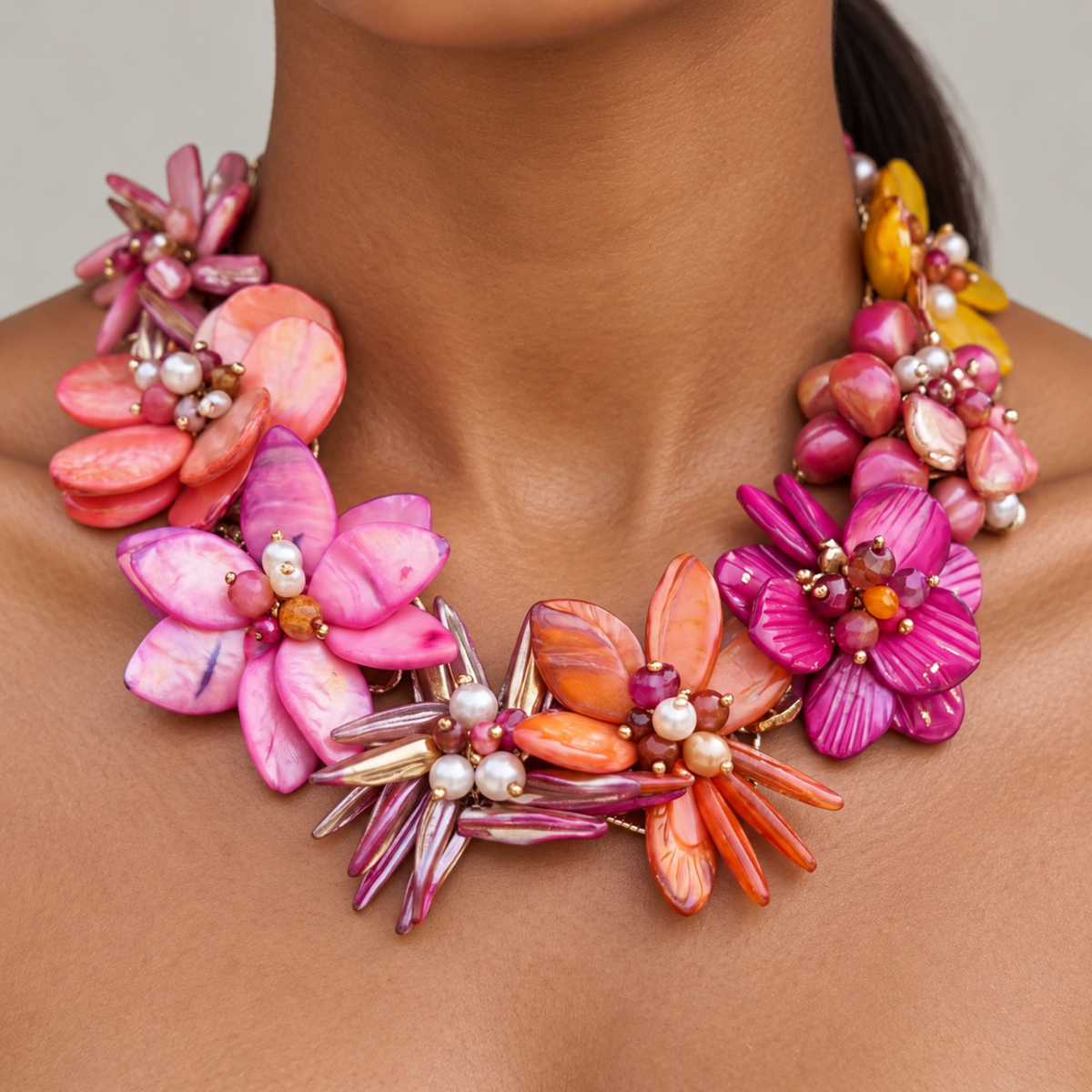 Wisteria Semi Precious Necklace featuring an asymmetrical bouquet of iridescent abalone shell flowers in pink, orange, coral and purple tones.