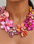 Wisteria Semi Precious Necklace featuring an asymmetrical bouquet of iridescent abalone shell flowers in pink, orange, coral and purple tones.