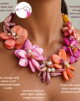 Close up of Wisteria necklace featuring sculptural pink, coral, orange and magenta abalone shell flowers with luminous pearls.