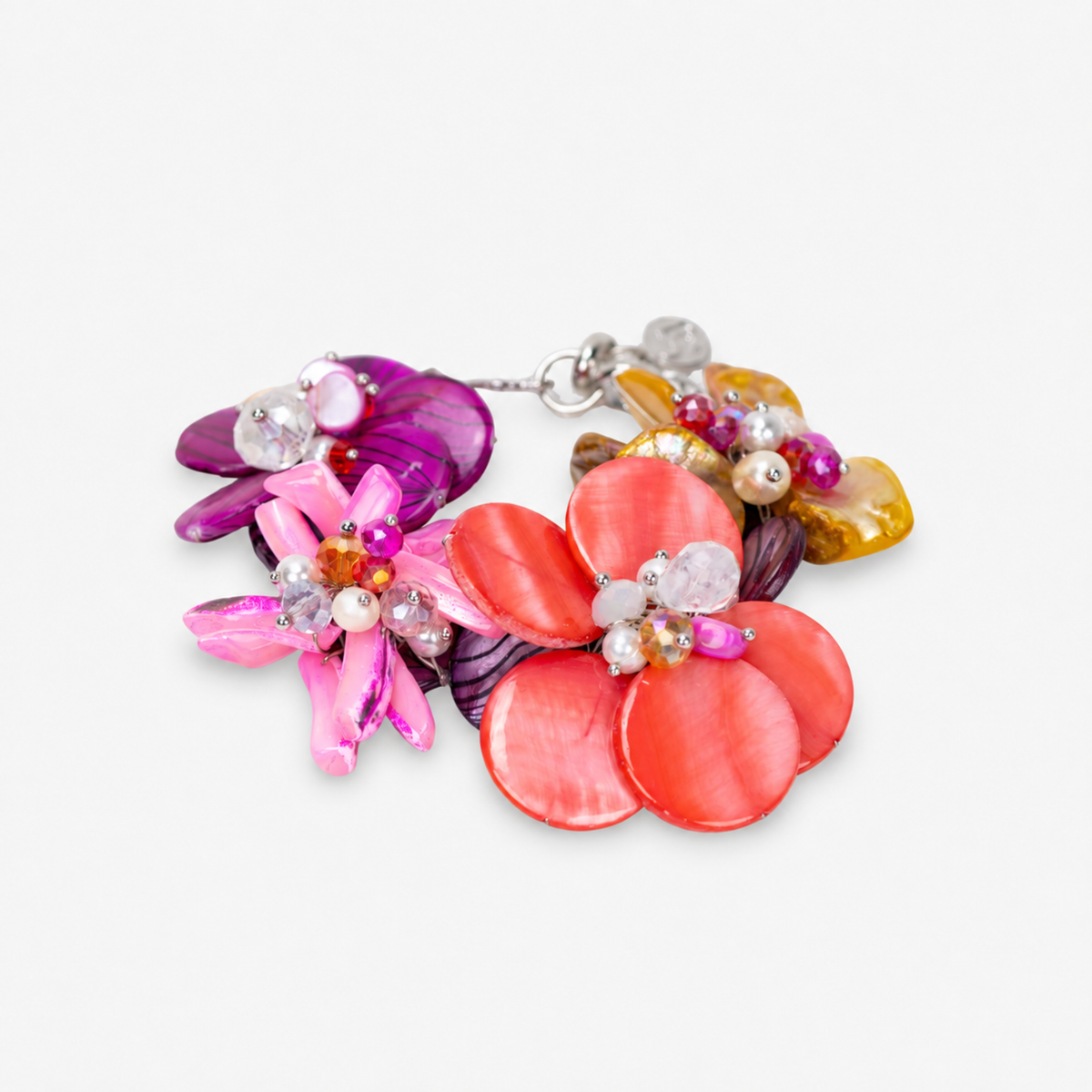 Colorful floral statement bracelet featuring iridescent pink abalone shell flowers, freshwater cultured pearls and dimensional bead details.
