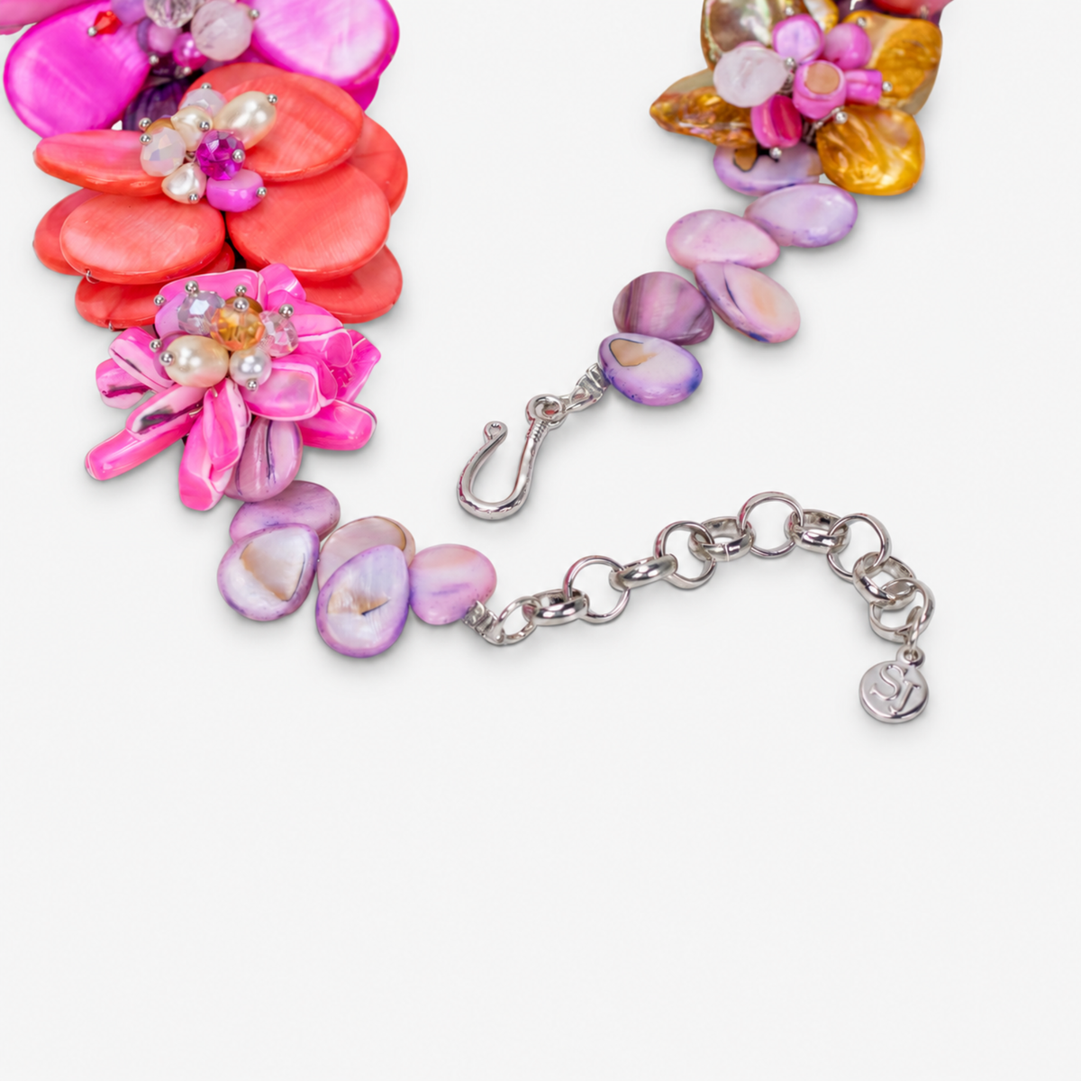 On model view of colorful Wisteria floral necklace featuring dimensional shell flowers, pearl centers and delicate gold colored details.