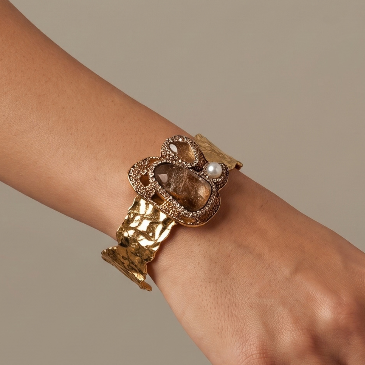 Sassy Jones Zahara Adjustable Cuff featuring an oversized brown centerpiece surrounded by sparkling crystals and golden accents.