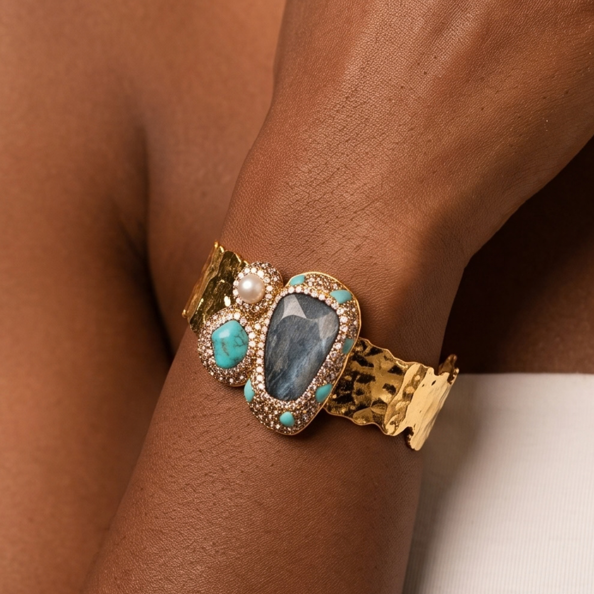 Sassy Jones Zahara Adjustable Cuff featuring a large deep blue centerpiece with veined teal stone accents.