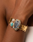 Sassy Jones Zahara Adjustable Cuff featuring a large deep blue centerpiece with veined teal stone accents.