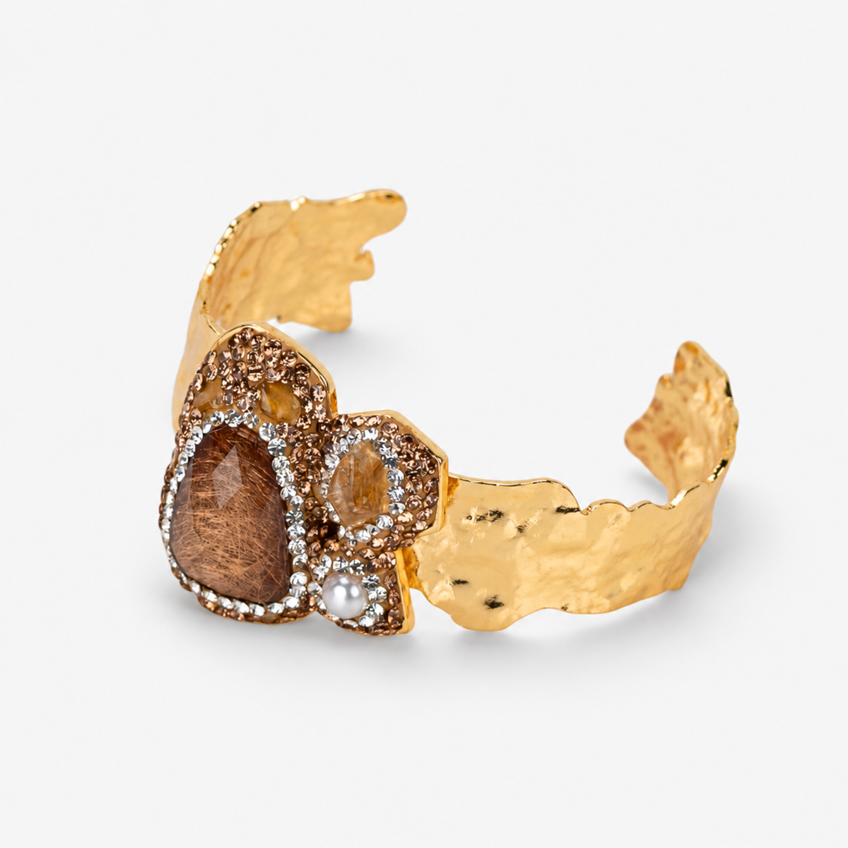 Cognac statement cuff featuring warm brown stones, a pearl accent and textured Gold tone finish.