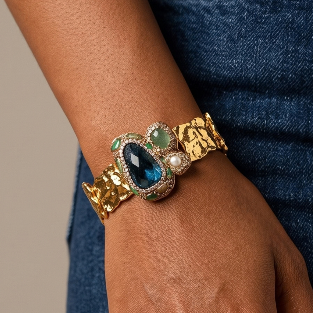 Sassy Jones Zahara Green cuff featuring an oversized jewel toned centerpiece with dimensional stone accents.