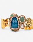 Zahara Adjustable Cuff in Green featuring a large deep green stone surrounded by crystal and pearl accents.