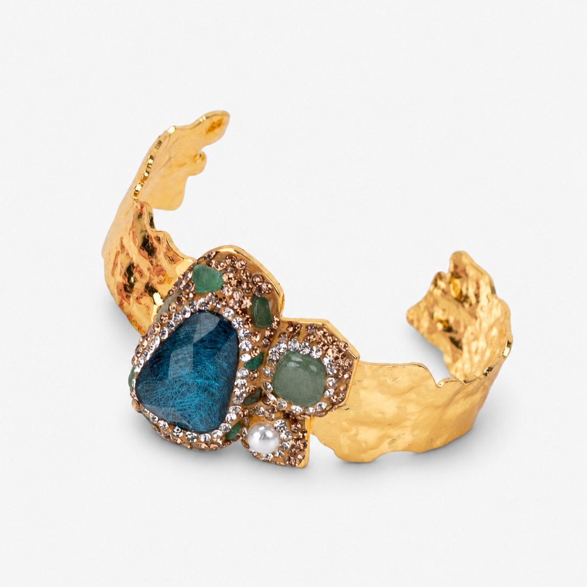 Green statement cuff featuring mixed green stones, sparkling crystals and textured Gold tone finish.