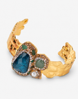 Green statement cuff featuring mixed green stones, sparkling crystals and textured Gold tone finish.