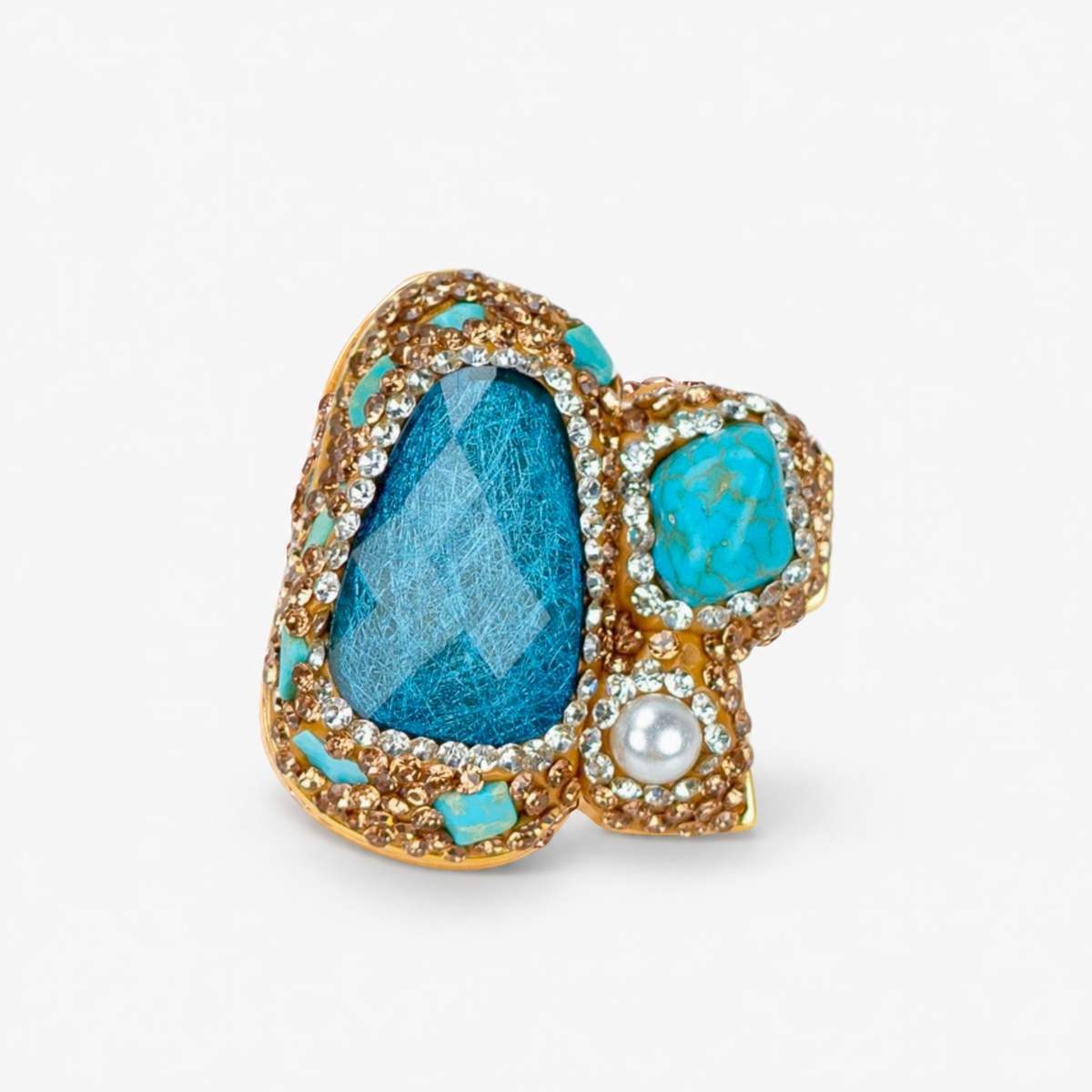 Zahara Sparkle Ring in Blue featuring a deep blue centerpiece with teal stones, pearl and crystal accents.
