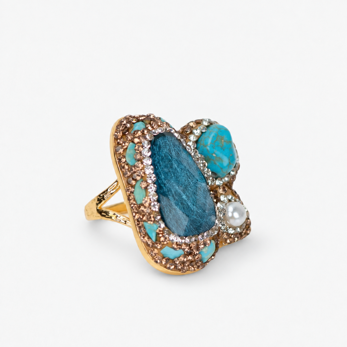 Blue statement ring featuring clustered blue green stones, a pearl accent and sparkling crystal detailing.