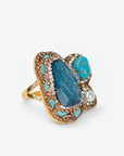 Blue statement ring featuring clustered blue green stones, a pearl accent and sparkling crystal detailing.
