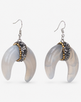 Close-up of Zuma Natural Shell Crystal Crescent Dangles with softly marbled shell and dimensional sparkling centers. 

Zuma crescent dangle earrings featuring organic shell variation, crystal detailing, and delicate hook ear wires.