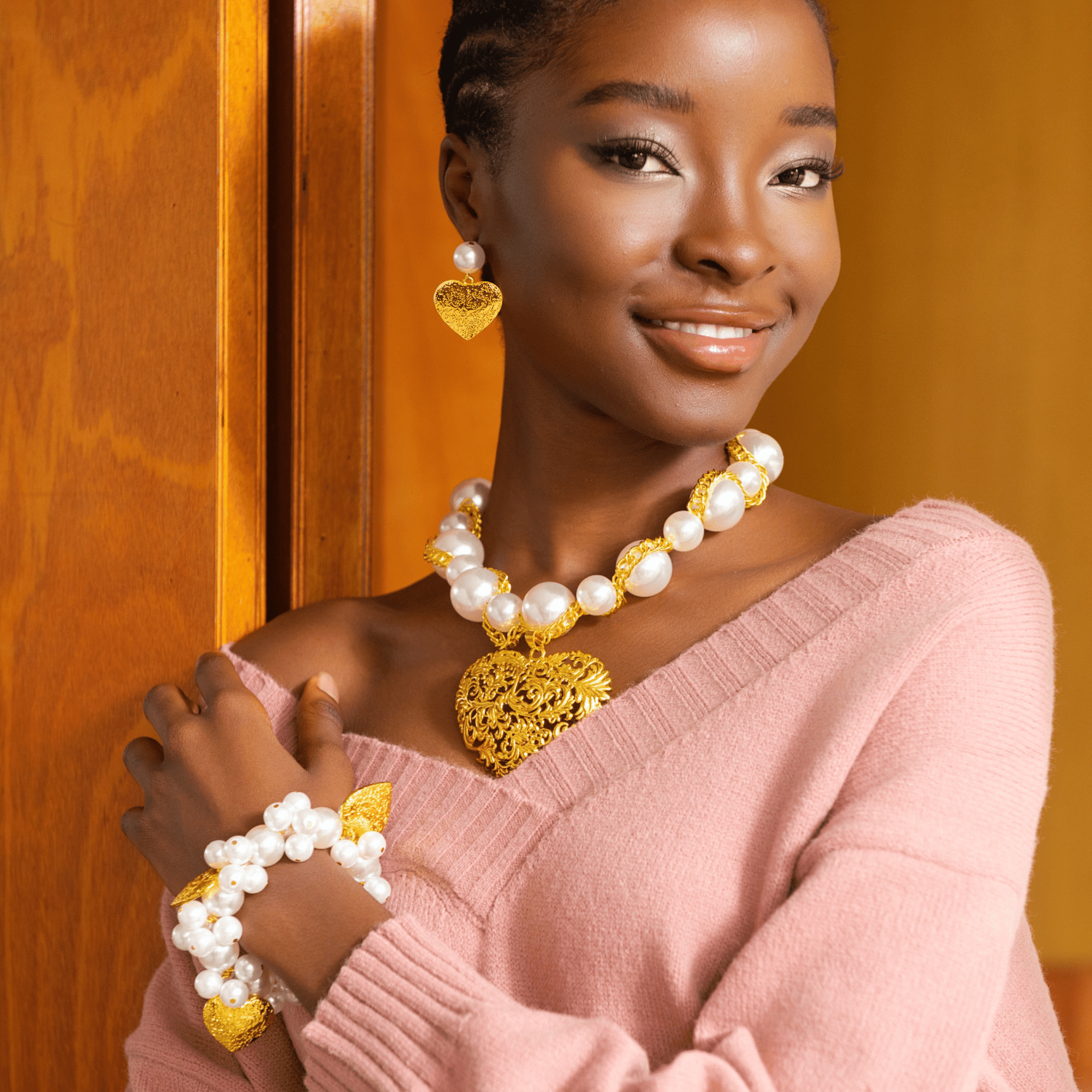 Full Amora jewelry set including necklace, earrings, and bracelet in ivory and gold.
