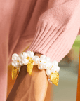 Side view of Amora bracelet featuring oversized pearls and gold charms.