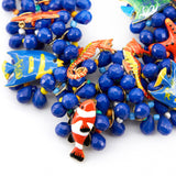 Caicos Bib - Sassy Jones, 4 strand design -Collar-length bib  -13 removable hand-painted resin-filled sea creature brooches with single-back prongs -Multi-faceted cobalt blue teardrop resin beads -Colorful seed bead spacer beads