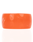 Chunky coral orange resin bangle bracelet with glossy translucent marbling on a white background.