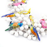 Kai Bib - Sassy Jones, 4 strand design
,Collar-length bib, removable hand-painted resin-filled and crystal-encrusted parrot brooches with single-back prongs, Multi-faceted white teardrop resin beads, 6 inch extender and hook closure, wedding jewelry, 